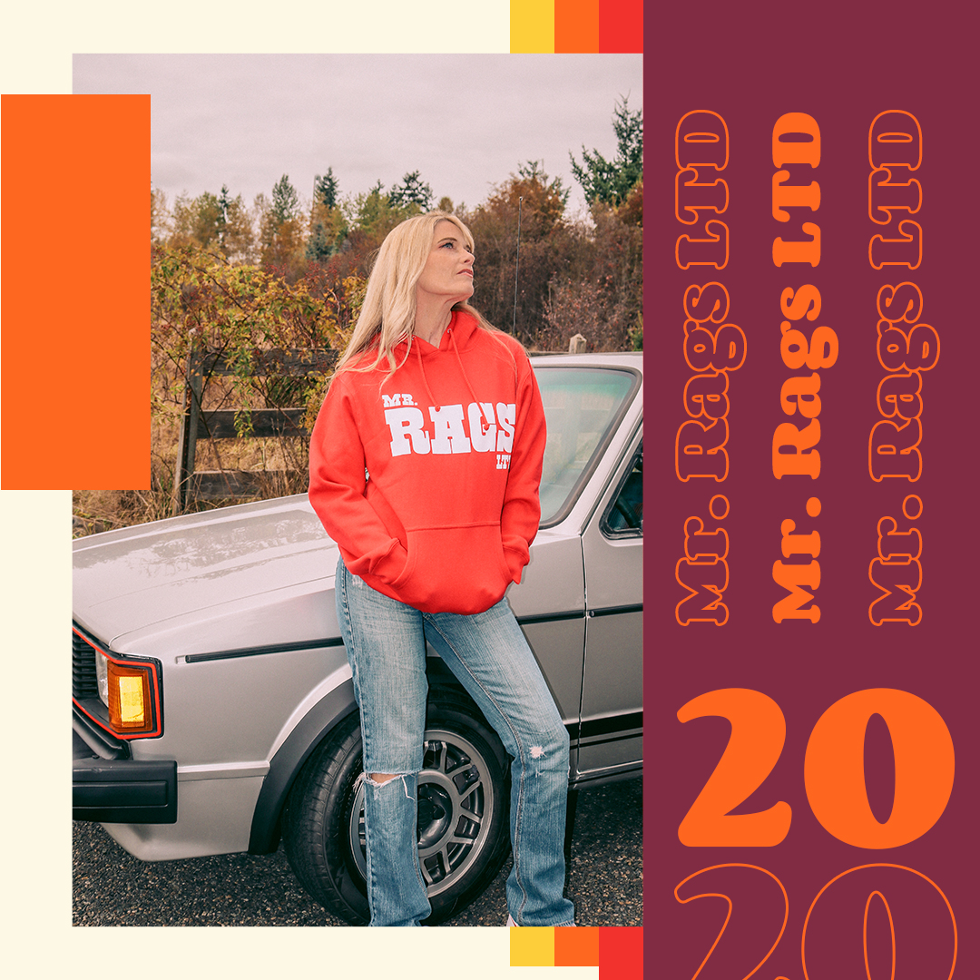 Model wearing a red Mr. Rags hoodie beside a vintage car